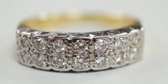 A modern 18ct gold and fourteen stone two row diamond set half hoop ring, size R/S, with textured