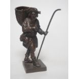 A 20th century bronze of a travelling salesman. 15cm tall