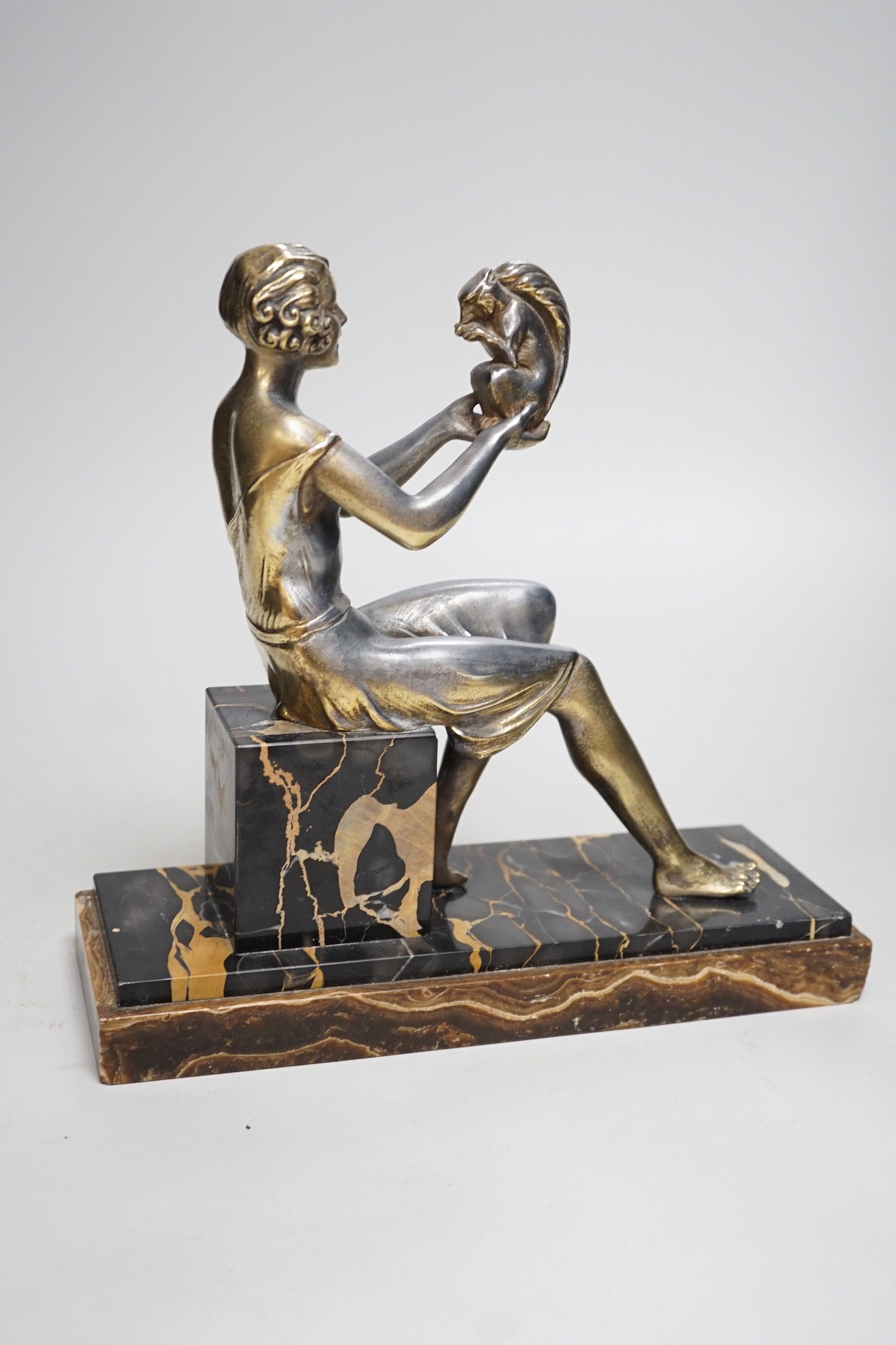 An Art Deco spelter gilded and silvered seated lady holding a squirrel, on marble and onyx mount, - Image 3 of 5