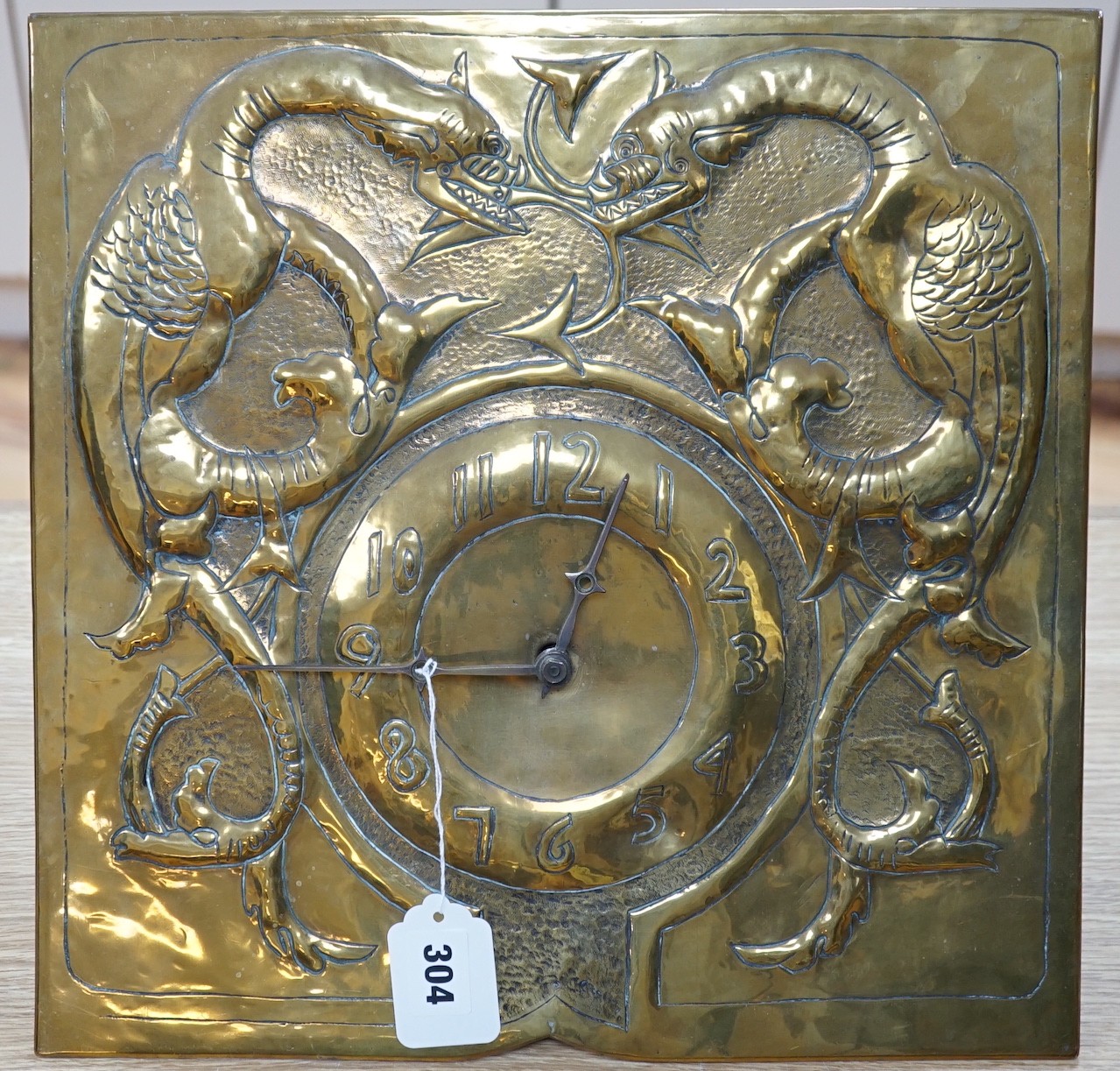 An early 20th Century Arts & Crafts/Art Nouveau brass wall clock in the manner of Margaret