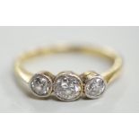 A mid 20th century 18ct, plat and three stone collet set diamond ring, size M, gross weight 2.5