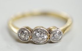 A mid 20th century 18ct, plat and three stone collet set diamond ring, size M, gross weight 2.5