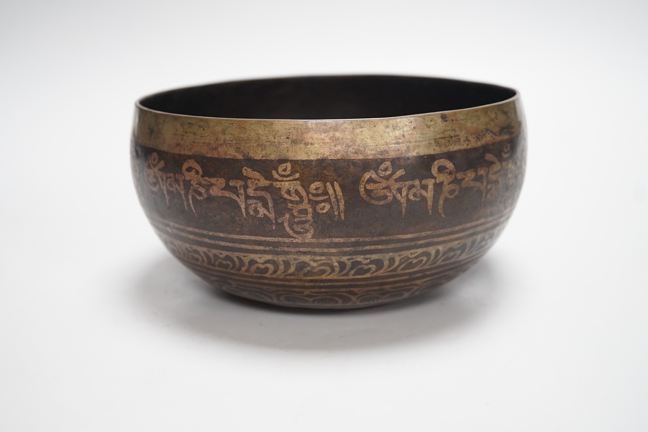 A bronze Nepalese temple bowl decorated with script, 18cm diameter - Image 3 of 5