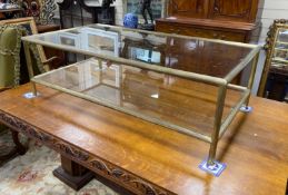 A Maison Jansen style rectangular glass and brass two tier coffee table, length 130cm, depth 70cm,