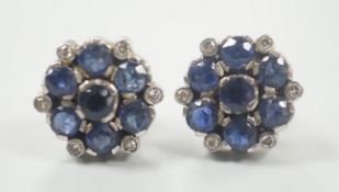 A pair of white metal, sapphire and diamond cluster set flower head ear studs, 10mm, gross weight