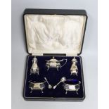 A cased George V silver five piece condiment set, Birmingham, 1921, with two associated spoons,