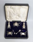 A cased George V silver five piece condiment set, Birmingham, 1921, with two associated spoons,