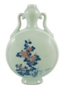 A Chinese underglaze blue and copper red inscribed celadon ground moonflask, 21cm high