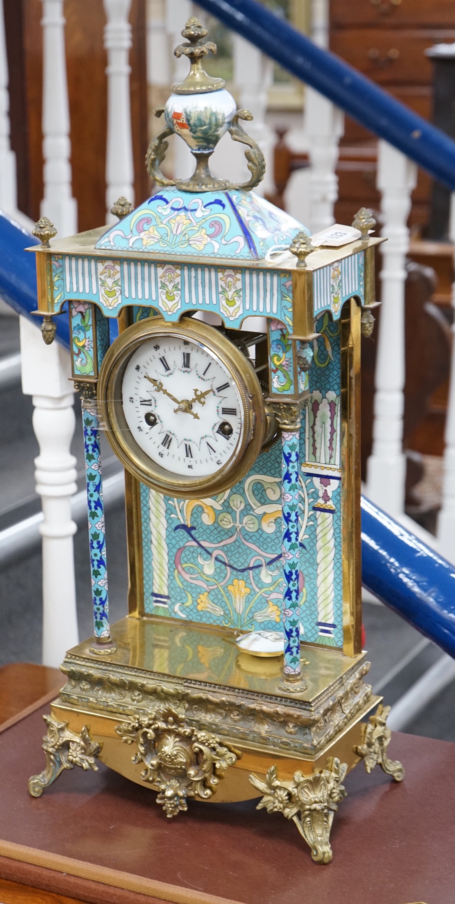 A large blue enamelled mantel clock with pendulum. 66cm tall