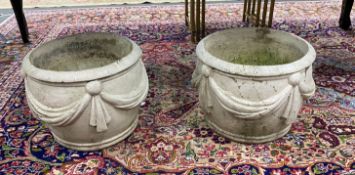 A pair of reconstituted stone circular garden planters with swagged bodies, diameter 38cm, height