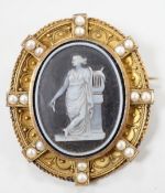 A Victorian canettile work yellow metal and sardonyx? cameo and split pearl set oval brooch,
