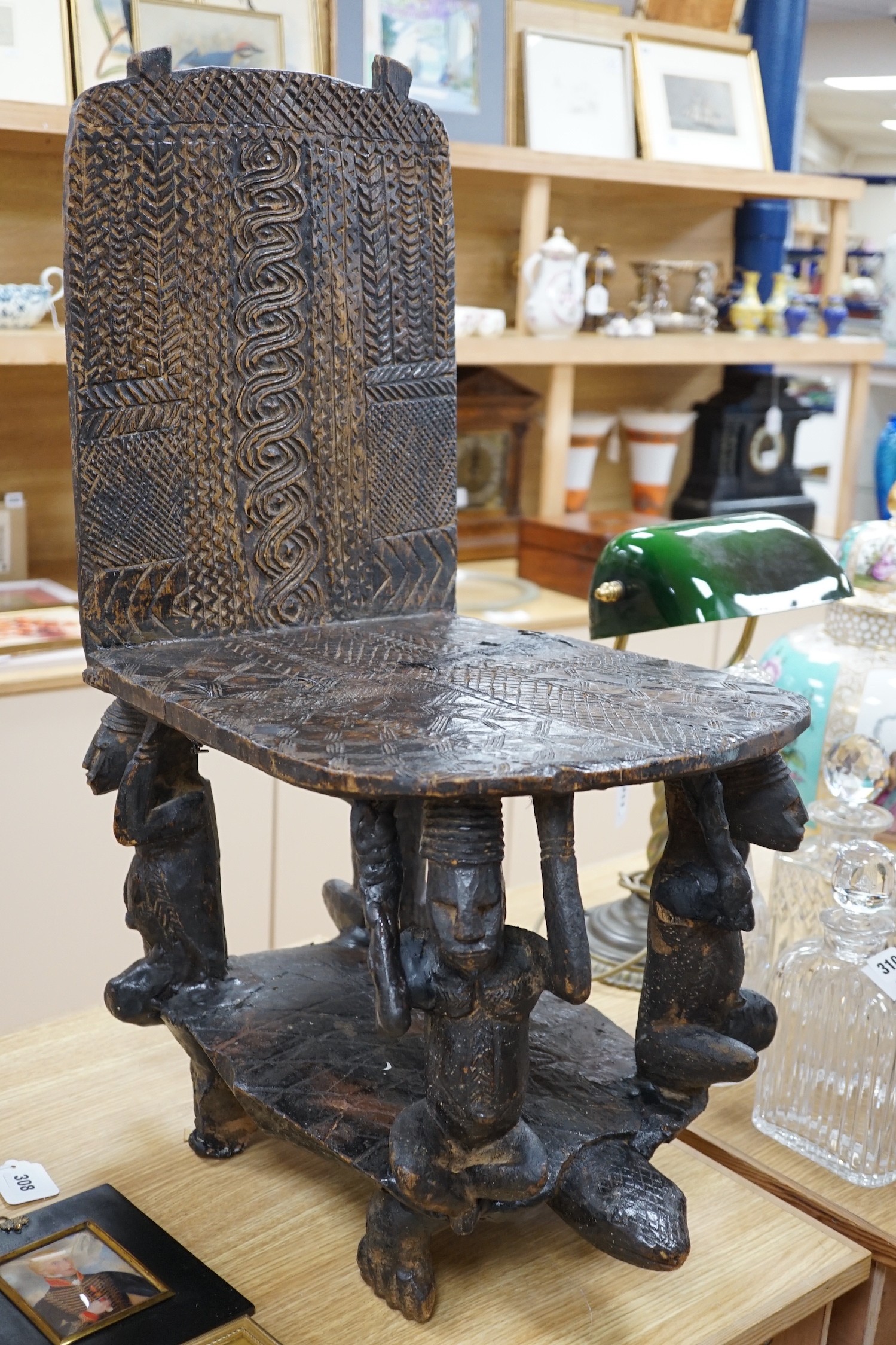 An African tribal carved hardwood chair, possibly Congo. 76cm tall