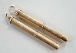 A 1950's engine turned 9ct gold mounted propelling toothpick, 48mm and a similar yellow metal