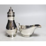 A George V silver sugar caster, Birmingham, 1932, 16.8cm and a silver sauce boat, 10.2oz.