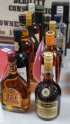 12 bottles of various alcohols to include a litre of Famous Grouse whisky, a litre of Bonaparte