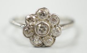 A 1920's 18ct, plat and millegrain set diamond flower head cluster ring, size O, gross weight 2.2
