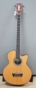 An Acoustic bass guitar, made by John Degay of Degay Guitars