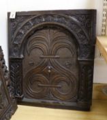 A 17th century style carved oak panel, 57cms wide x 64cms high