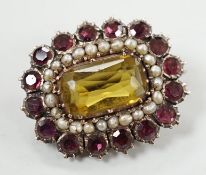 An early 19th century yellow metal, yellow paste, foil backed garnet and split pearl set oval