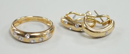 A modern 14k and gypsy set six stone diamond band, size N and a pair of matching earrings, gross