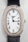 A lady's 2010 18ct white gold and diamond set Longines oval quartz wrist watch, with Roman dial,