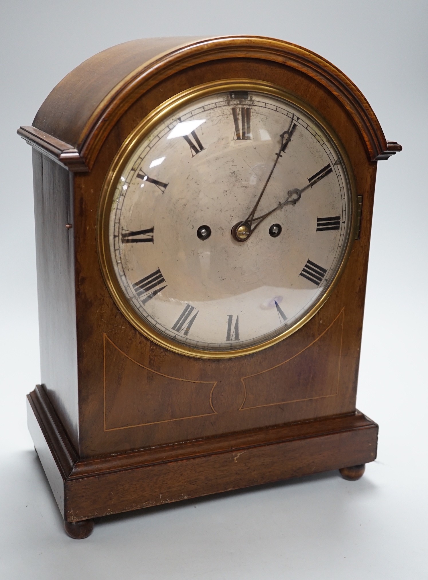 A late 19th/early 20th century mahogany mantel clock with German striking movement and convex
