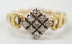 An 18ct and nine stone diamond set table ring, with pierced shoulders, size M/N, gross weight 3.7