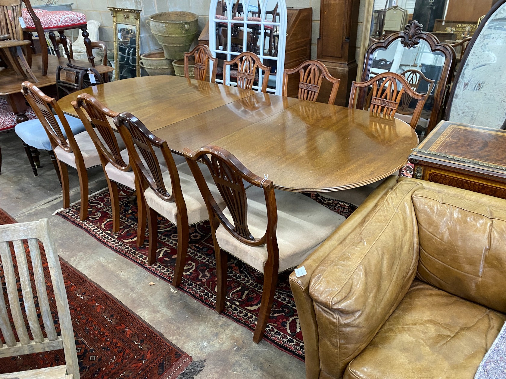 A William Tillman reproduction mahogany twin pedestal extending dining table, length 244cm extended,