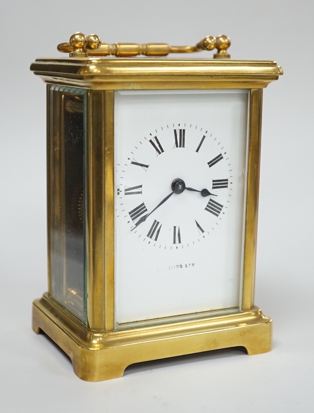 A brass cased carriage timepiece with key