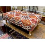 A large contemporary rectangular footstool upholstered in Kilim style fabric on turned beech feet,