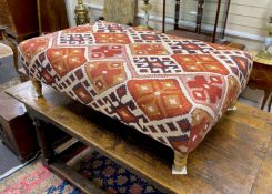 A large contemporary rectangular footstool upholstered in Kilim style fabric on turned beech feet,