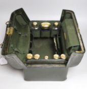 A late Victorian leather Gladstone toilet case, containing eight silver gilt mounted glass toilet