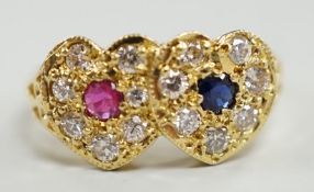 A modern 18ct gold, ruby, sapphire and diamond set twin heart cluster ring, size M, gross weight 4