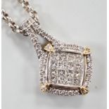 A modern 14k yellow and white metal, pave set diamond pendant, 23mm, on a Chinese? white metal