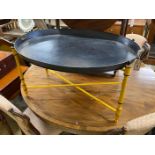 An oval Regency style toleware tray top table on folding stand, width 80cm, depth 61cm, height 43cm