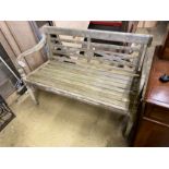 A weathered hardwood garden bench, length 115cm, depth 49cm, height 85cm