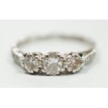 A white metal, stamped plat and three stone diamond set ring, size M/N, gross weight 2.8 grams, with