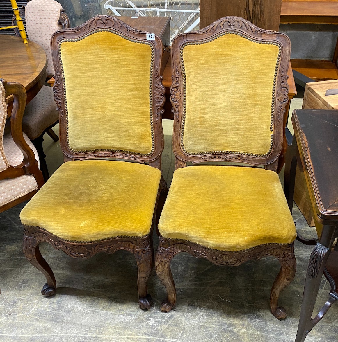 A pair of Louis XVI style upholstered carved oak dining chairs, width 46cm, depth 42cm, height