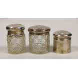 Two early 20th century silver mounted glass Reynolds angel lid toilet jars, tallest 89mm and one