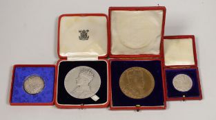 A cased George VI coronation silver medal, matt, smaller medal and an Edward VII coronation medal,
