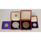 A cased George VI coronation silver medal, matt, smaller medal and an Edward VII coronation medal,