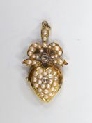 An Edwardian yellow metal, rose cut diamond and split pearl cluster set heart shaped locket pendant,