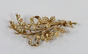 An Edwardian 15ct and seed pearl set floral spray brooch, 76mm, gross weight 13.5 grams.