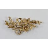 An Edwardian 15ct and seed pearl set floral spray brooch, 76mm, gross weight 13.5 grams.