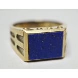 A modern 585 yellow metal and lapis lazuli set signet ring, size W, gross weight 11.9 grams.