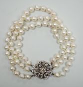 A 1960's triple strand cultured pearl bracelet, with 9ct white gold and diamond chip set clasp,