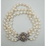 A 1960's triple strand cultured pearl bracelet, with 9ct white gold and diamond chip set clasp,