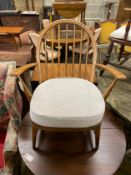 An Ercol beech comb back armchair, width 64cm, depth 52cm, height 81cm