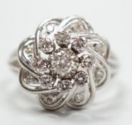 A French white metal (18ct poincon mark) and diamond cluster set dress ring, size L/M, gross