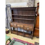 An 18th century oak potboard dresser with boarded rack, length 170cm, depth 40cm, height 197cm